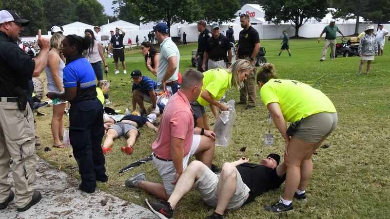 Spectators are tended to after a lightning strike on the course left several injured during a...