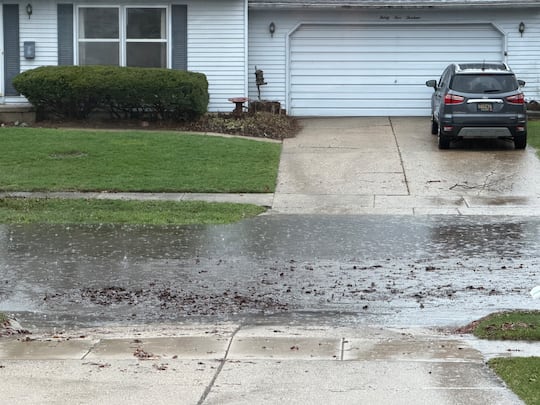 Flooding in a neighborhood on the west side of Lansing Saturday morning
