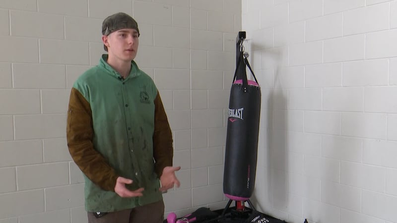 Student at Wilson Talent Center welds punching bag for peers