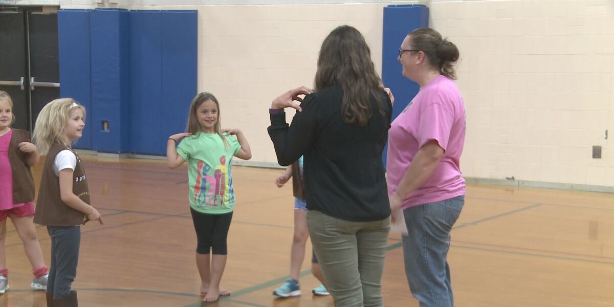 Scou Sign Language Girl Scouts learning sign language to better communicate with new member